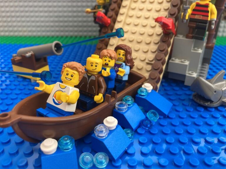 Family in a boat coming down a water slide in a big splash as a great birthday day out idea