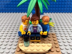 Two boys crowding around their mother begging to go on the big water slide