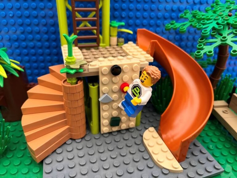 Child climbing up a climbing wall at a play park