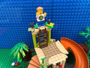 Child standing happily at the top of the climbing frame
