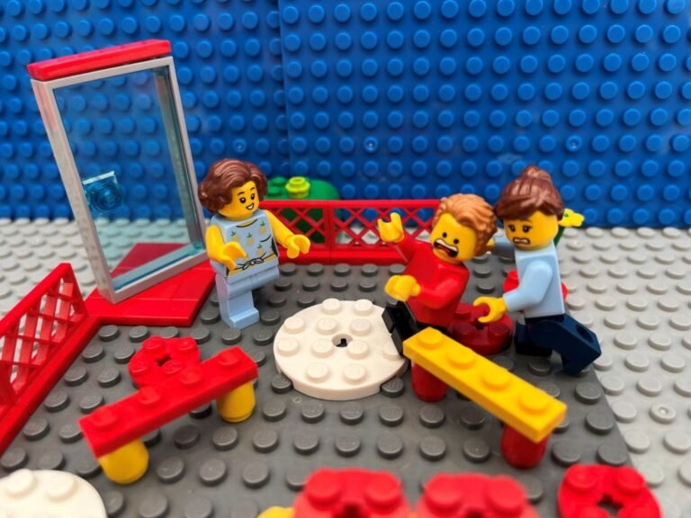 Mum pushing young child who is struggling with school separation anxiety towards the teacher in the school playground